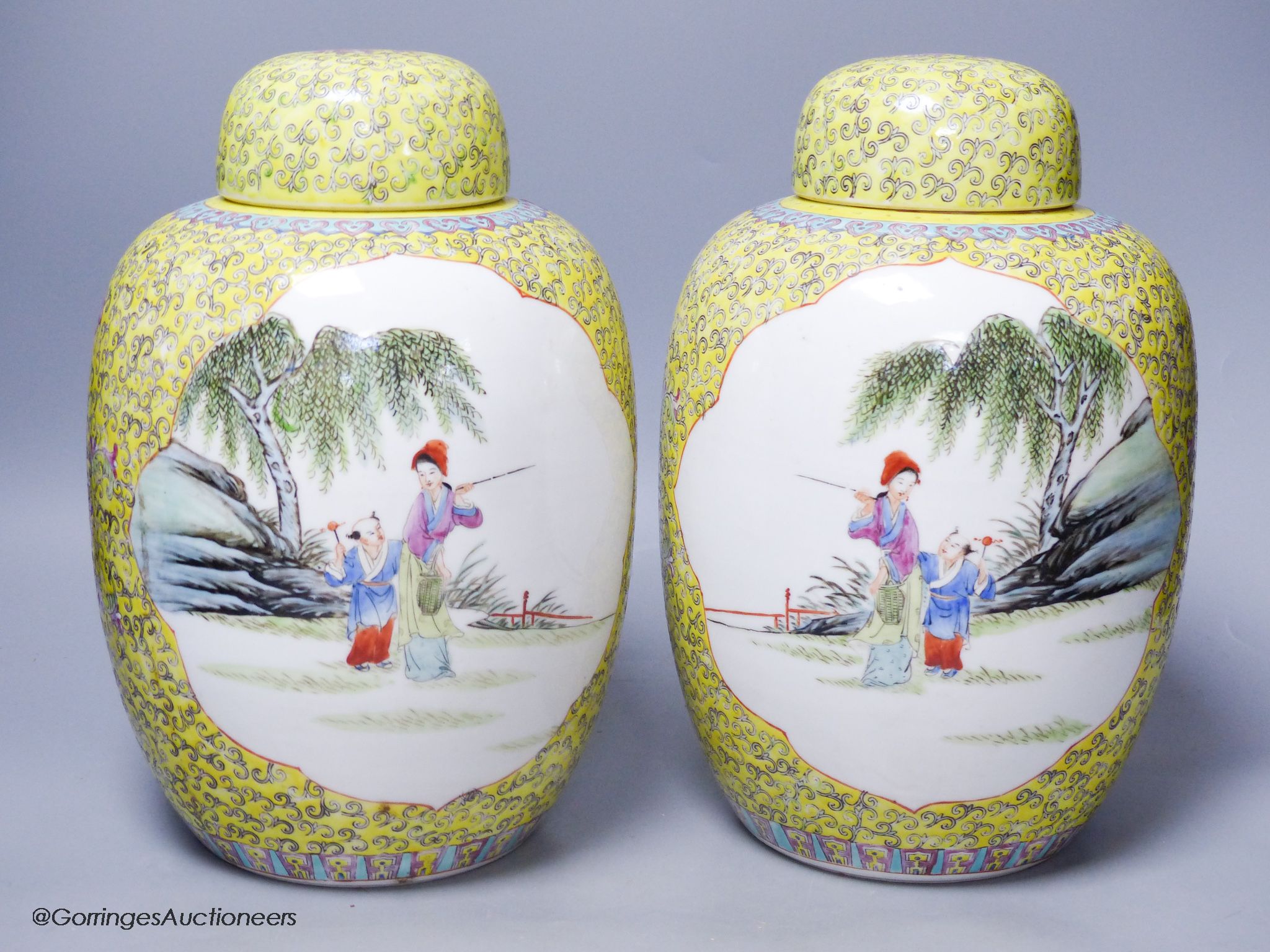 A pair of Chinese yellow ground vases and covers, height 30cm